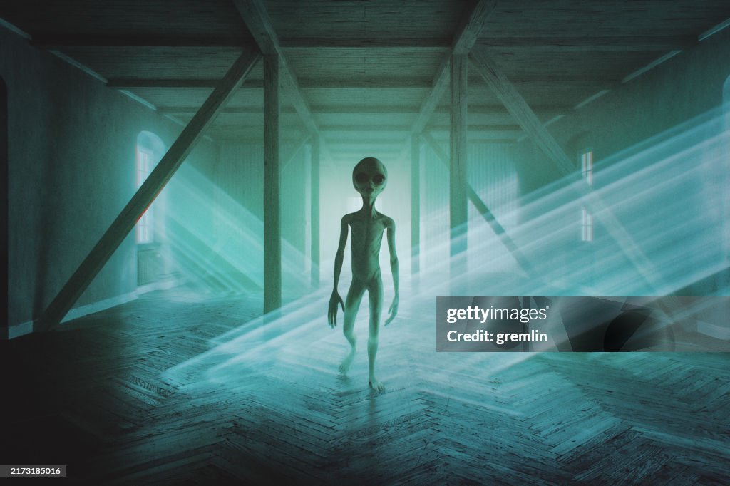 Spooky alien walking in empty farmhouse at night