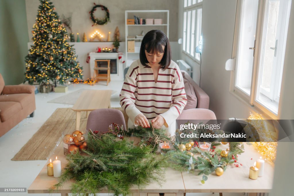 Young woman making a Christmas wreath