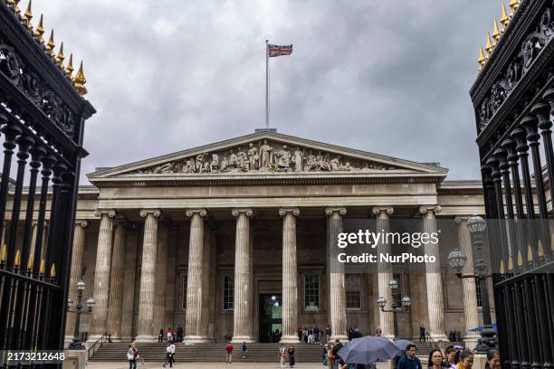 General view of the exterior of the British Museum during a cloudy day with showers, with tourists and visitors entering and departing. The British...