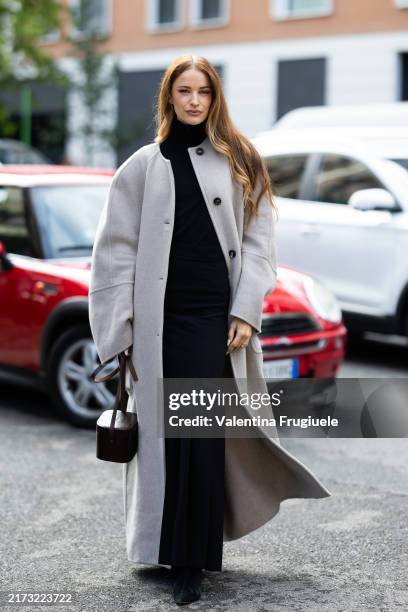 Victoria Magrath wears black shoes, a brown leather bag, a black turtle neck dress and a dove grey coat outside Max Mara show during the Milan...