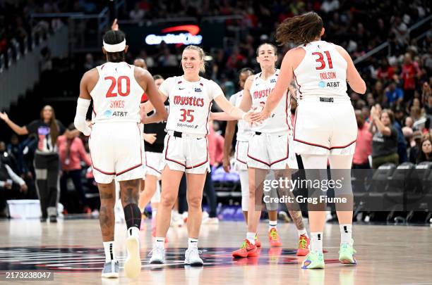 Julie Vanloo of the Washington Mystics celebrates with teammates in the third quarter against the Indiana Fever at Capital One Arena on September 19,...