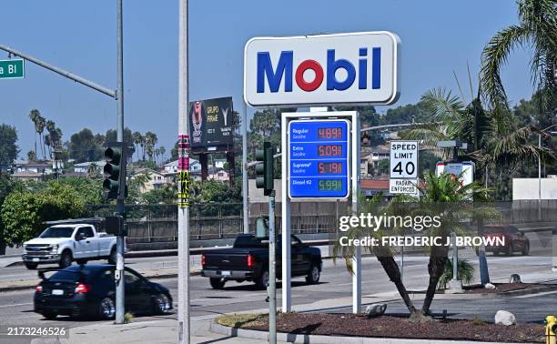 Vehicles pass an ExxonMobil gas station on September 23, 2024 in Rosemead, California. California said Monday it was suing oil giant ExxonMobil over...