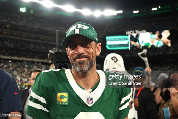Aaron Rodgers of the New York Jets smiles after defeating the New England Patriots in the game at MetLife Stadium on September 19, 2024 in East...