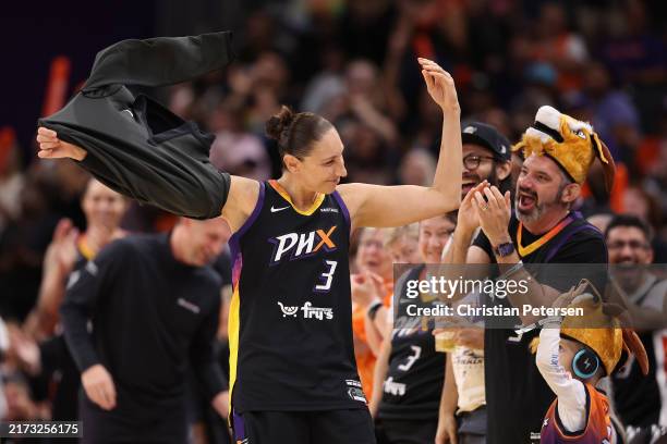 Diana Taurasi of the Phoenix Mercury reacts to fans cheering as she checks back into the second half of the WNBA game against the Seattle Storm at...