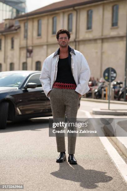 Marc Forne wearing a white jacket over a black tank top, gray trousers, black shoes is seen outside the Prada show during the Milan Fashion Week...