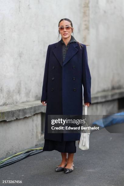 Tamara Kalinic dark brown sunglasses, dark gray Prada sweater, navy blue wool coat, shiny black pointed toe ballerina leather flats, white Prada...