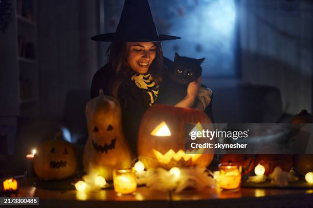 happy witch with black cat on halloween night. - bruxa imagens e fotografias de stock