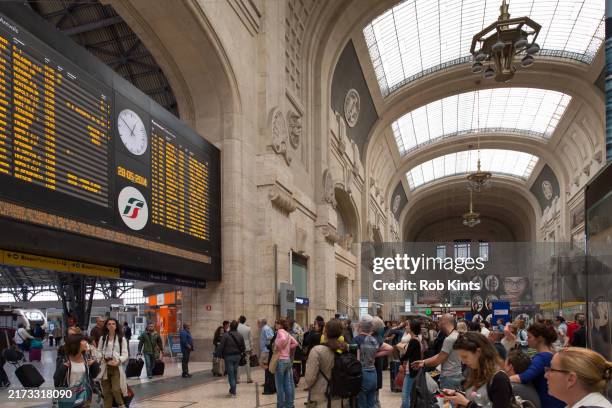people watching the arrival and departures board on milano centrale railway station - busy train platform stock pictures, royalty-free photos & images