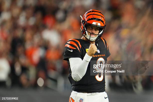 Joe Burrow of the Cincinnati Bengals celebrates after scoring a touchdown against the Washington Commanders during the first half of an NFL football...