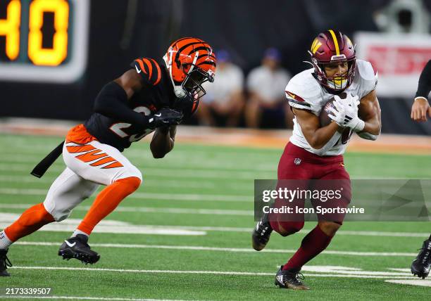 Washington Commanders running back Austin Ekeler eludes Cincinnati Bengals cornerback Dax Hill in a game between the Washington Commanders and the...