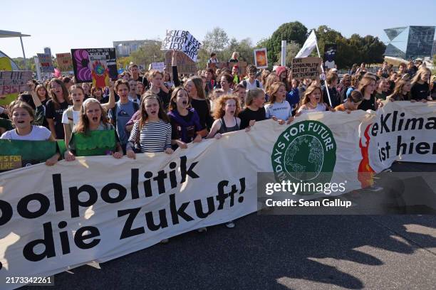 Supporters of the Fridays for Future climate action movement march during an FFF Global Climate Strike on September 20, 2024 in Berlin, Germany....