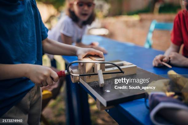close-up of woodworking activity taught to children. - hand saw stock pictures, royalty-free photos & images