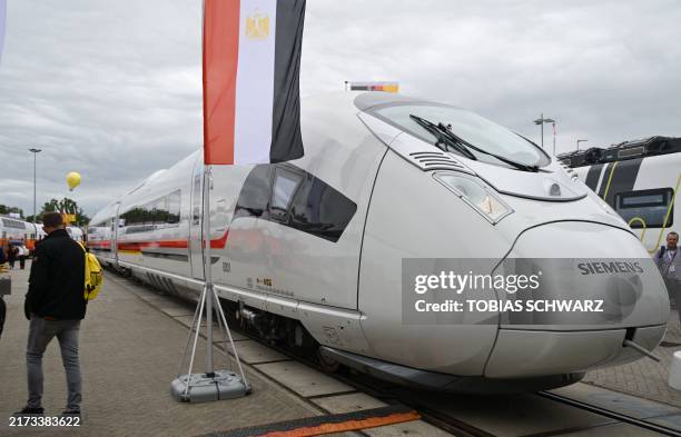 Visitors take a look at a Velaro highspeed train produced for Egypt by German industrial giant Siemens at the InnoTrans fair, an international...