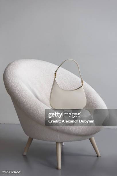 fashion luxury women white leather bag on chair indoors.concept fashion and sale of clothes and accessories - bolso de piel fotografías e imágenes de stock