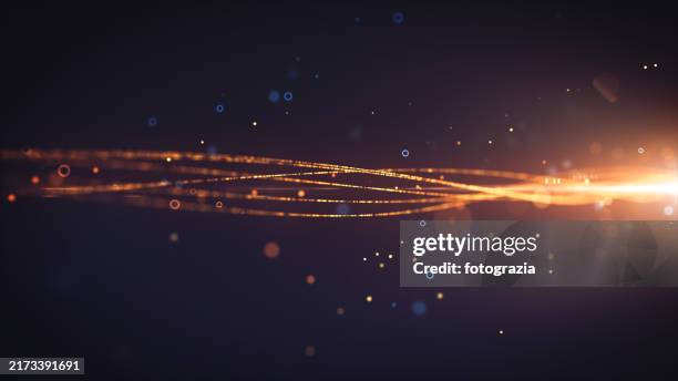 bright orange glowing light trails crossing in fluid motion - producción de combustible y energía fotografías e imágenes de stock