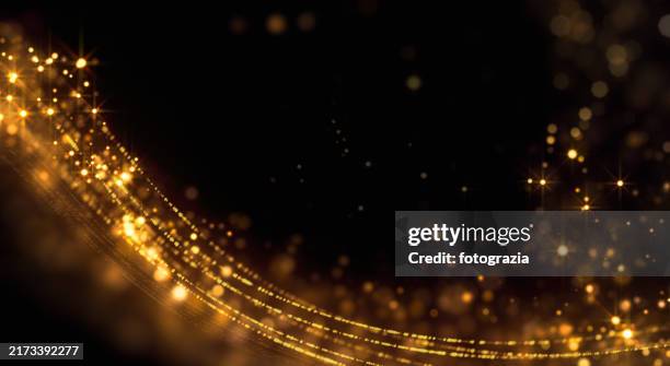 golden glittering streaks and sparkling bokeh lights with copy space - nominierung stock-fotos und bilder