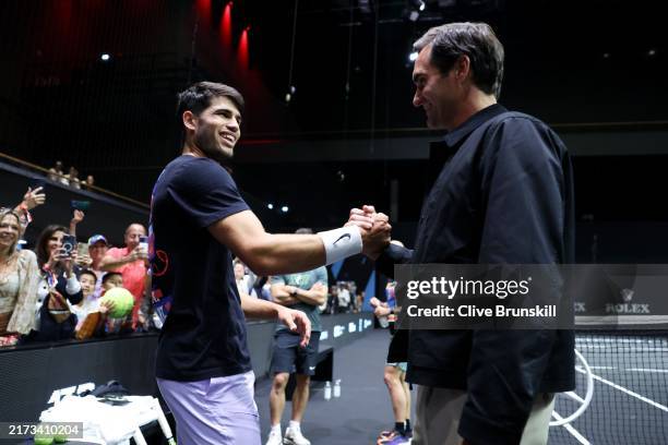 Roger Federer and Carlos Alcaraz of Team Europe shake hands during a Team Europe Practice Session on the practice court on day one of Laver Cup at...