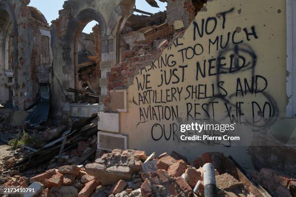 Graffiti on the wall of the bombed train station calls for increased weapon deliveries from foreign partners on September 24, 2024 in Kostyantynivka,...
