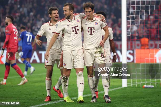 Leon Goretzka of Bayern Muenchen celebrates the team's ninth goal with teammates Thomas Mueller and Harry Kane during the UEFA Champions League...
