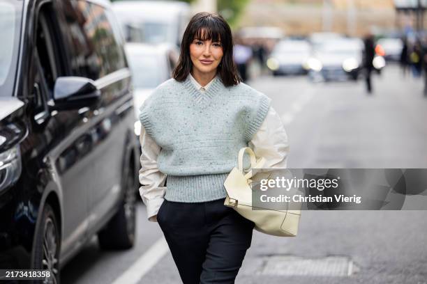 Alexandra Pereira wears beige bag, black pants, green sleeveless pullunder, white button shirt outside Tods during the Milan Fashion Week Menswear...