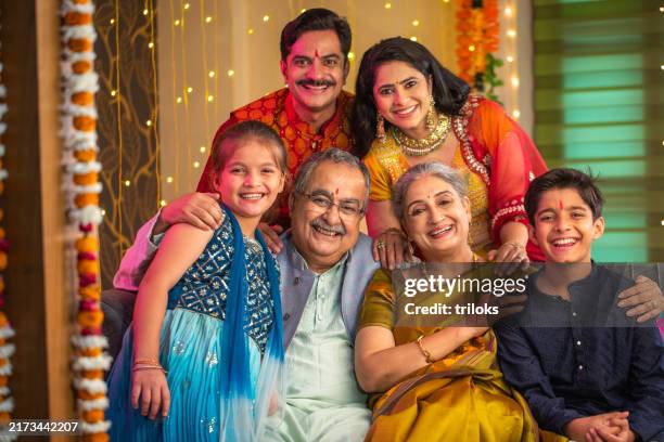 happy multi-generation family portrait during diwali - hindoeïsme stockfoto's en -beelden