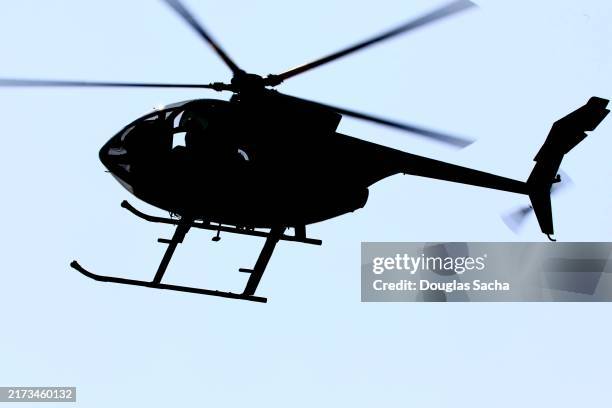 small utility helicopter in silhouette - rettungshubschrauber stock-fotos und bilder
