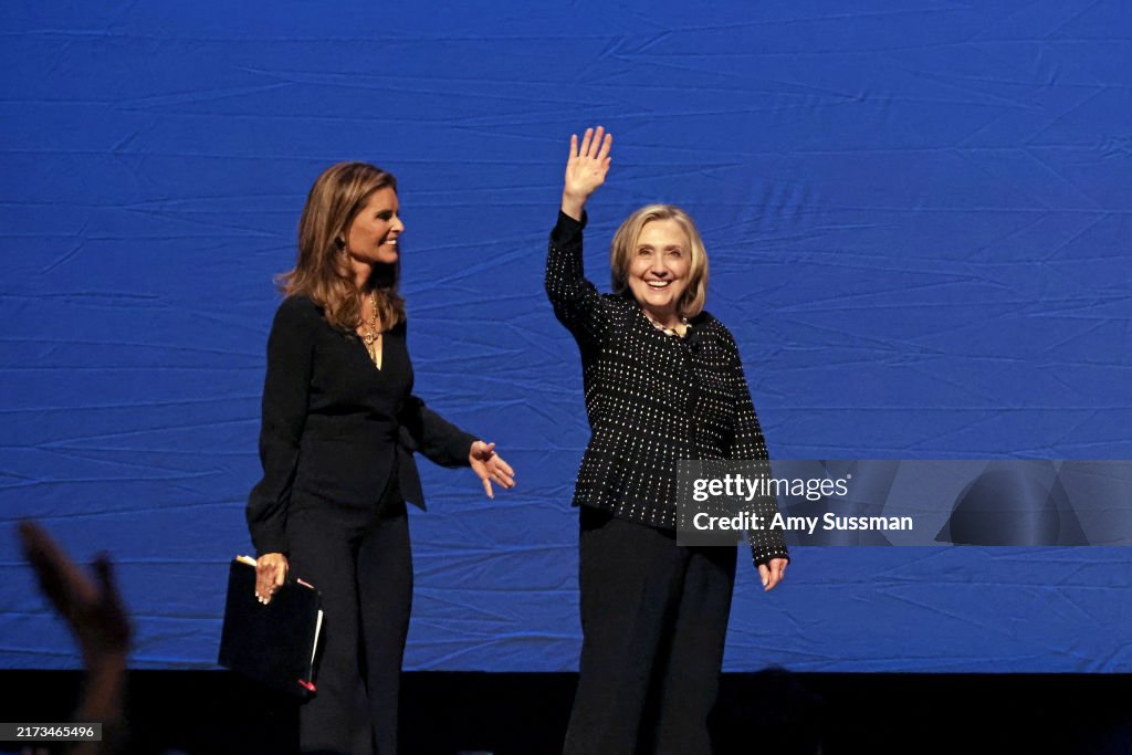 Maria Rodham Hillary Rodham Clinton walks onstage with Maria Shriver for a... News ...