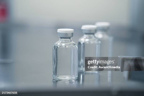 rows of sterile bottles in a pharmaceutical factory - laboratory glassware stock pictures, royalty-free photos & images