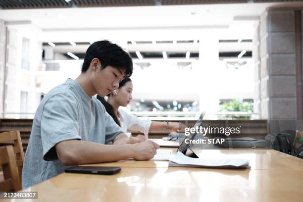 asian students studying in the library - chinese ethnicity stock pictures, royalty-free photos & images