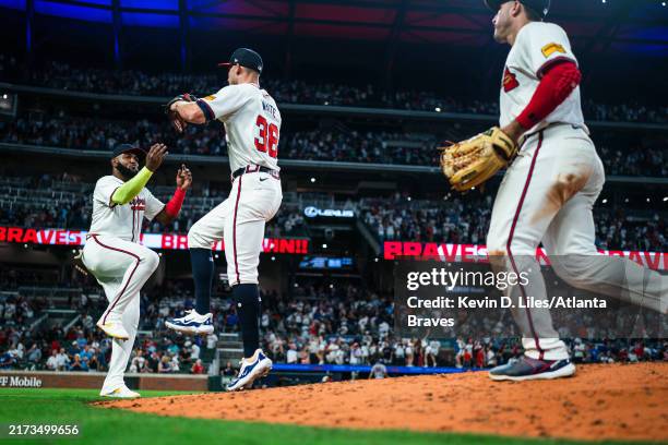 Marcell Ozuna and Eli White of the Atlanta Braves celebrate after defeating the New York Mets at Truist Park on September 24, 2024 in Atlanta,...