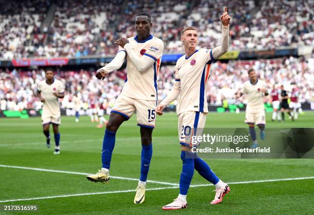 Cole Palmer of Chelsea celebrates scoring his team's third goal with teammate Nicolas Jackson during the Premier League match between West Ham United...