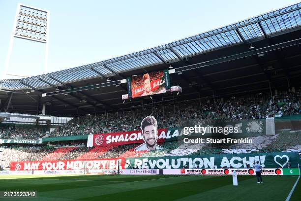 Fans display a tiffo that reads "Shalom, salam, peace, may your memory be a revolution, achi" during the Bundesliga match between SV Werder Bremen...
