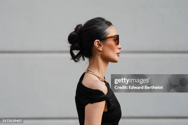 Heart Evangelista wears dark brown sunglasses, silver necklace, outside Philosophy, during the Milan Fashion Week Spring/Summer 2024-2025 on...