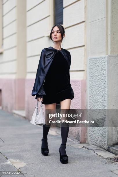 Heart Evangelista wears black long sleeve Max Mara mini dress, light blue Max Mara leather bag, black socks, black open toe platform heels with...