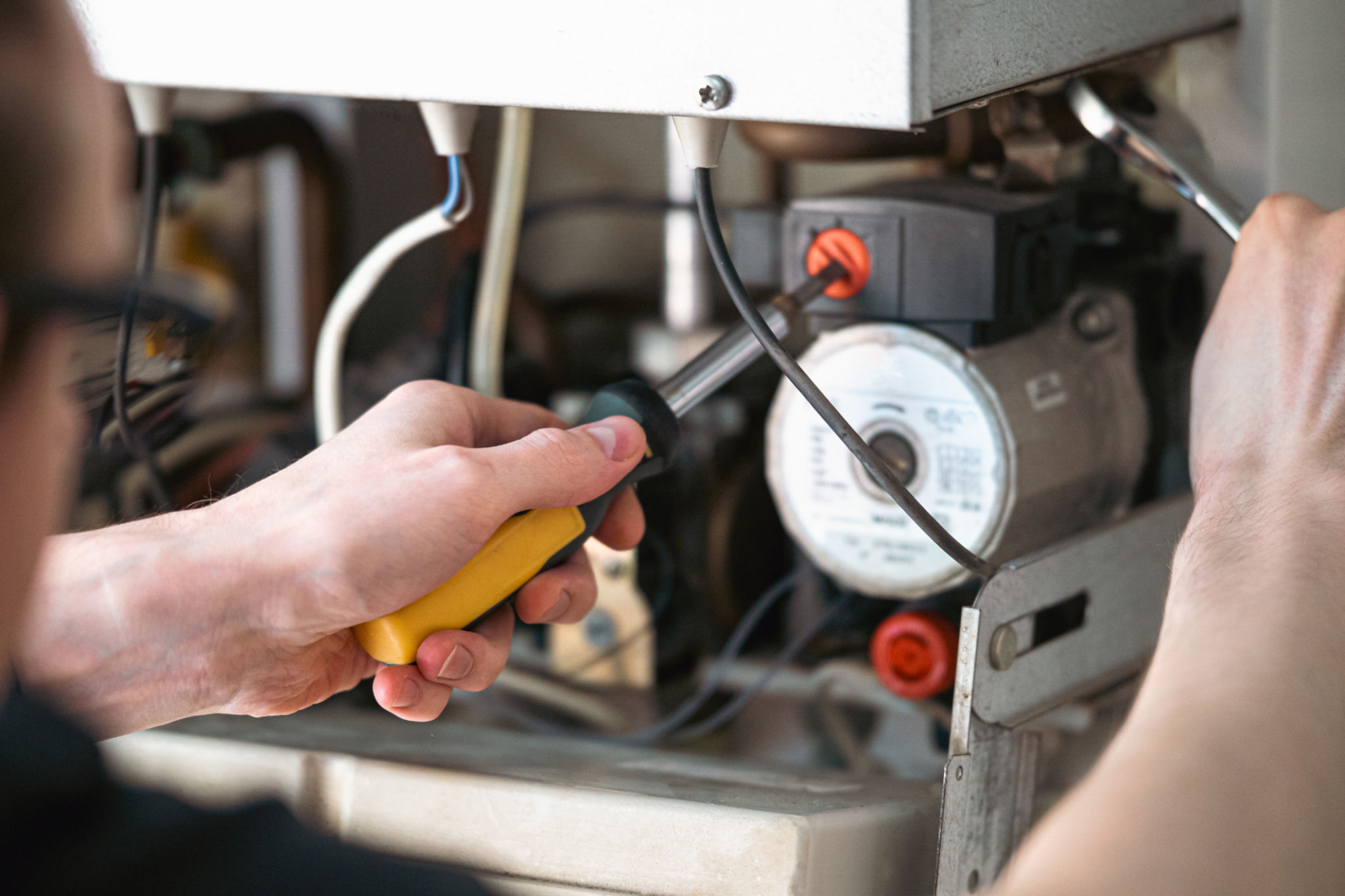 plumber inspecting heater