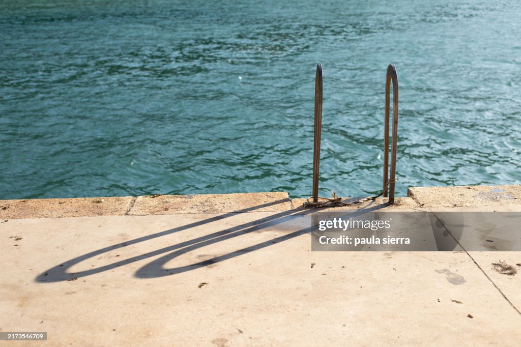 Stairs leading to sea at sunset