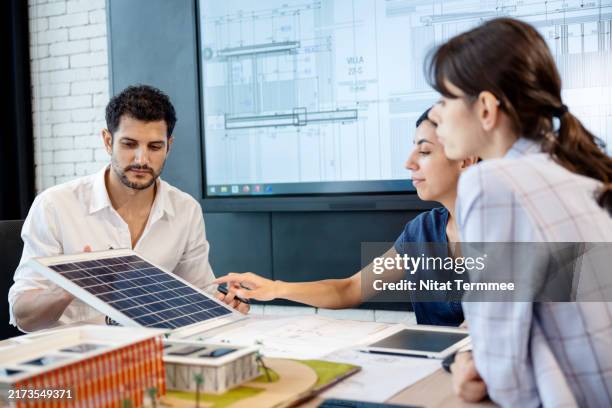 project status meetings help in brainstorming solutions as a team in construction design. construction management solution and technology. - architect cad stock pictures, royalty-free photos & images