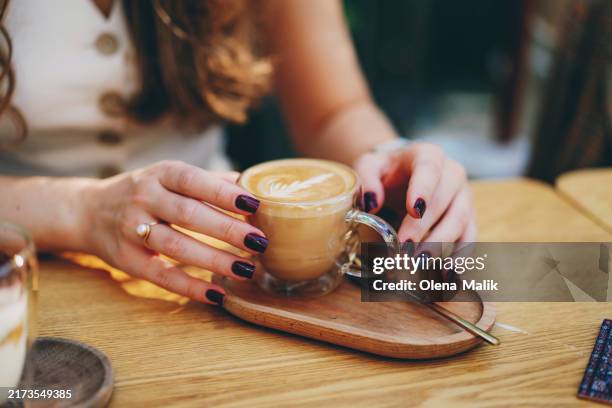 female hands holding a cup of cappuccino - coffee bildbanksfoton och bilder