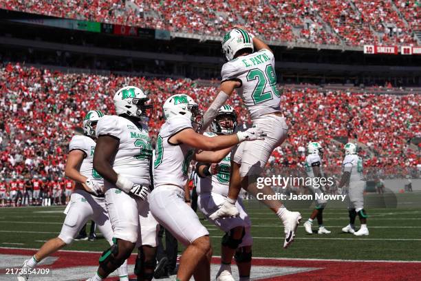 Running back Ethan Payne of the Marshall Thundering Herd celebrates a touchdown with his teammates during the first quarter against the Ohio State...