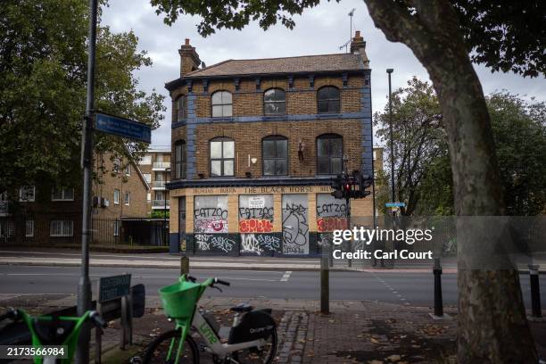 The boarded up Black Horse pub is pictured on September 25, 2024 in London, England. Fifty pubs a month have closed in the first half of 2024...