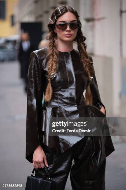 Guest wears jacket from leather in Ferrari during the Milan Fashion Week Menswear Spring/Summer 2025 on September 21, 2024 in Milan, Italy.