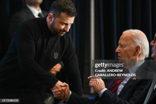 Ukrainian President Volodymyr Zelensky shakes hands with US President Joe Biden during an event with world leaders launching a Joint Declaration of...