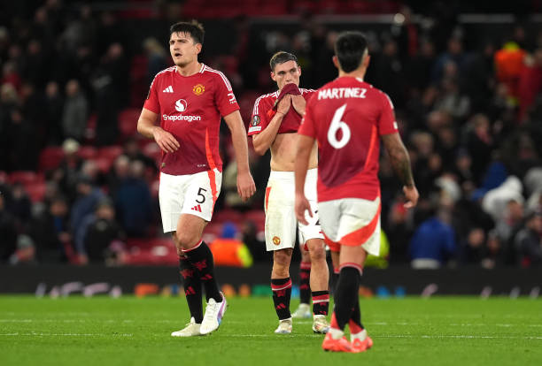 Manchester United's Manuel Ugarte , Harry Maguire and Lisandro Martinez look frustrated after the final whistle in the UEFA Europa League match at...
