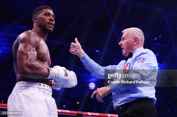 Anthony Joshua reacts as he is counted down by referee Marcus McDonnell during the IBF World Heavyweight Title fight between Daniel Dubois and...