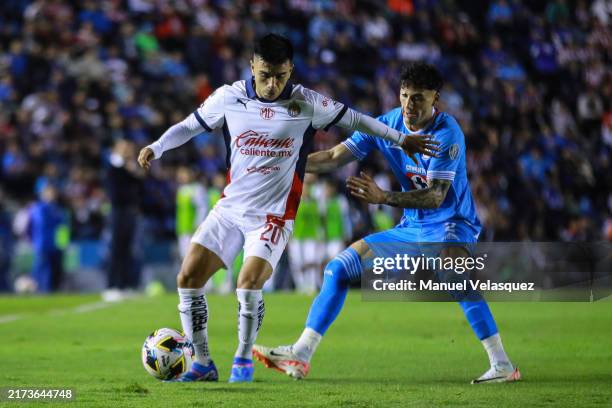 Fernando Beltran of Chivas competes for the ball against Jorge Sanchez of Cruz Azul during the 9th round match between Cruz Azul and Chivas as part...