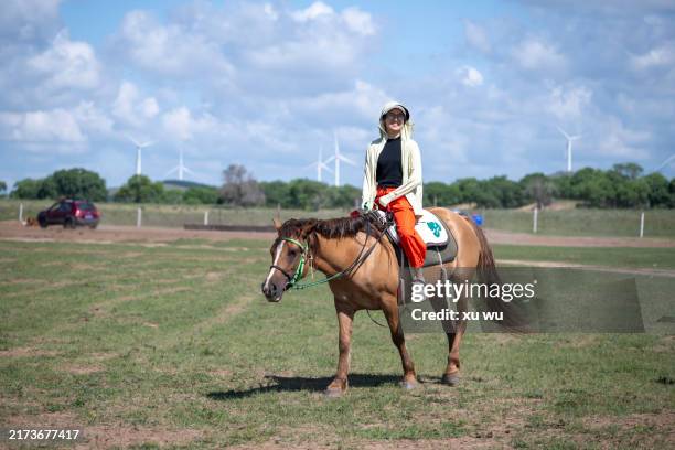 women riding horses in prairie tourism - mongolian kids stock pictures, royalty-free photos & images