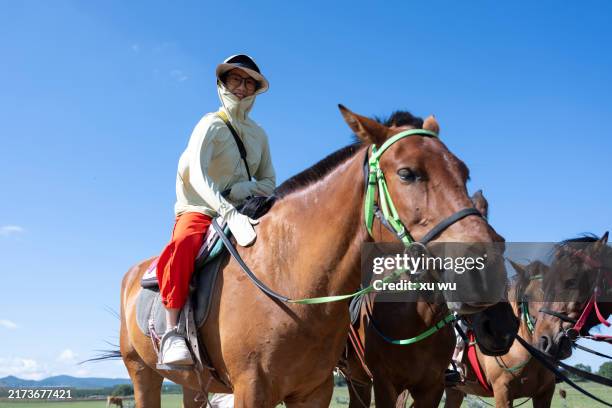 women riding horses in prairie tourism - mongolian kids stock pictures, royalty-free photos & images
