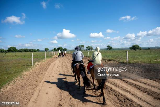 women riding horses in prairie tourism - mongolian kids stock pictures, royalty-free photos & images