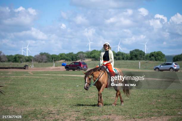women riding horses in prairie tourism - mongolian kids stock pictures, royalty-free photos & images
