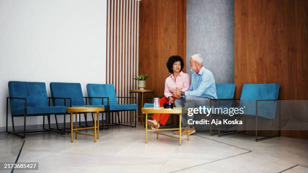 mature couple together in the waiting room. - waiting room stock pictures, royalty-free photos & images